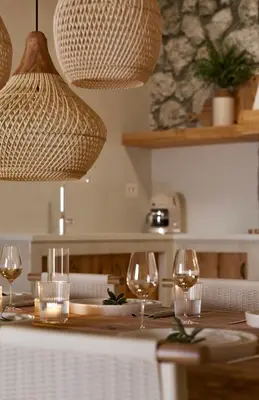 a table with two glasses of wine on it at Elaia Luxury House in Archangelos
