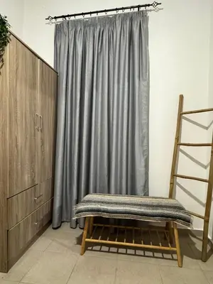 a bench in a room with a curtain and a ladder at Alleyhouse 83 in Kremasti