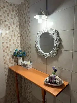 a bathroom with a mirror and a wooden table at Alleyhouse 83 in Kremasti