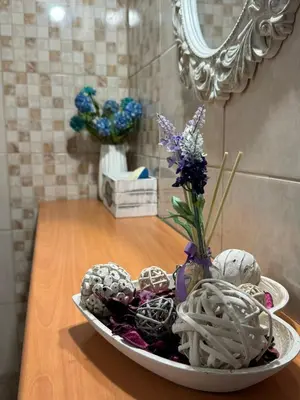 a bowl of decorated easter eggs on a table with a mirror at Alleyhouse 83 in Kremasti