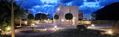 a building with lights in front of it at night at Villa Libre Mare, your cozy vacation villa in Pefki Rhodes