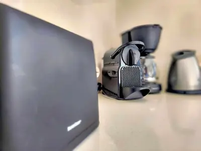 a laptop computer sitting on a counter next to a coffee maker at Villa Libre Mare, your cozy vacation villa in Pefki Rhodes