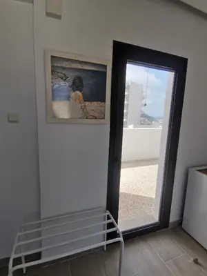 a room with a mirror and a framed picture on the wall at 3rd floor apartment in town with sea view in Rhodes Town
