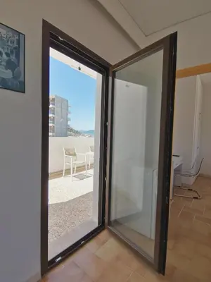 a sliding glass door with a view of a patio at 3rd floor apartment in town with sea view in Rhodes Town