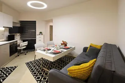 a living room with a couch and a table at Uni cozy city apartment in Rhodes Town