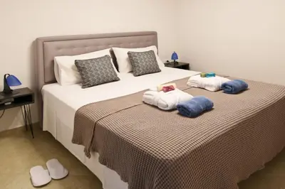 a bedroom with a bed with two towels on it at Uni cozy city apartment in Rhodes Town