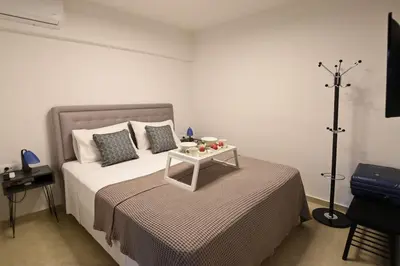 a bedroom with a bed with a table on it at Uni cozy city apartment in Rhodes Town
