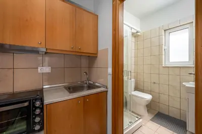 a small kitchen with a sink and a toilet at Elli Beach Downtown Apartments in Rhodes Town