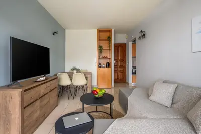 a living room with a couch and a flat screen tv at Elli Beach Downtown Apartments in Rhodes Town
