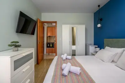 a bedroom with a bed with two towels on it at Elli Beach Downtown Apartments in Rhodes Town
