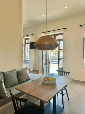 a dining room table with a bowl of fruit on it at Serenity Suites in Halki