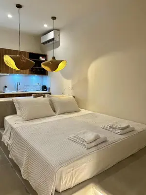 a bedroom with a white bed with towels on it at Serenity Suites in Halki
