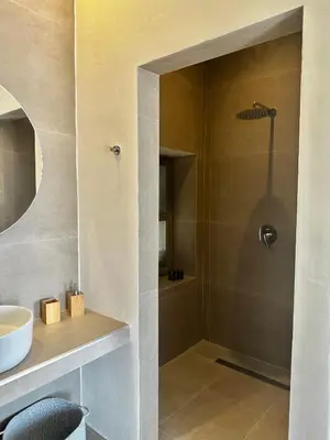 a bathroom with a shower and a sink at Serenity Suites in Halki