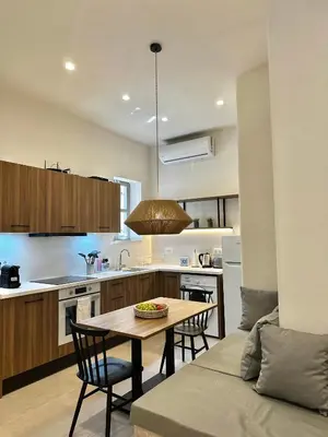 a kitchen with a table and chairs in a kitchen at Serenity Suites in Halki