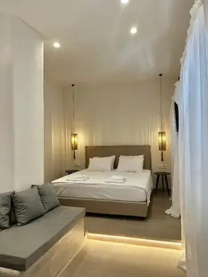 a bedroom with a bed and a couch in it at Serenity Suites in Halki