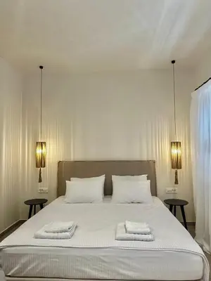 a bedroom with a bed with two towels on it at Serenity Suites in Halki