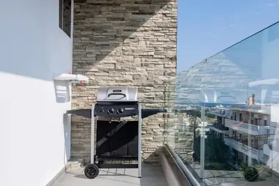 a kitchen with a stove and a stone wall at Smart Luxury Apartments #1 in Rhodes Town