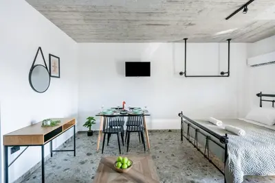 a bedroom with a bed and a table and a dining room at Smart Luxury Apartments #1 in Rhodes Town