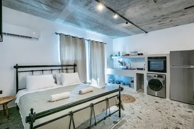 a bedroom with a large bed and a kitchen at Smart Luxury Apartments #1 in Rhodes Town
