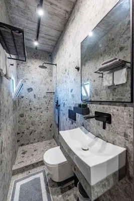 a bathroom with a white sink and a toilet at Smart Luxury Apartments #1 in Rhodes Town