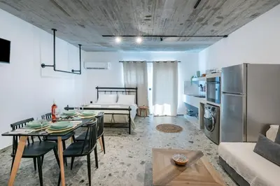 a kitchen and living room with a table and a couch at Smart Luxury Apartments #1 in Rhodes Town