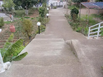 a concrete sidewalk with lights on the side of it at Antouan Matina in Archangelos