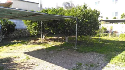 a shade structure in a yard with a tree at Antouan Matina in Archangelos
