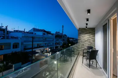 a balcony with chairs and a view of a building at Smart Luxury Apartments #2 in Rhodes Town