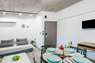 a living room with a table and a couch at Smart Luxury Apartments #2 in Rhodes Town