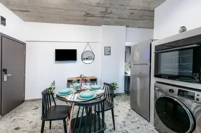a kitchen with a table with chairs and a microwave at Smart Luxury Apartments #2 in Rhodes Town