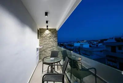 a balcony with a table and chairs and a blue screen at Smart Luxury Apartments #2 in Rhodes Town