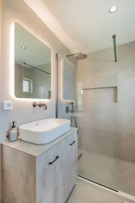 a bathroom with a sink and a shower at Anthemis modern & spacious in Koskinou