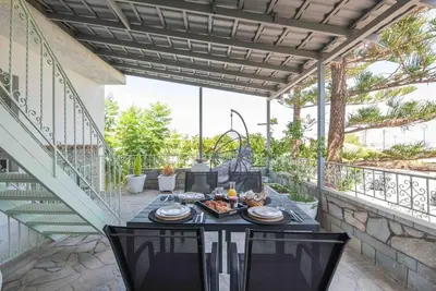 a patio with a table with food on it at Anthemis modern & spacious in Koskinou