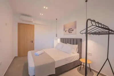 a small bedroom with a bed and a tripod at Anthemis modern & spacious in Koskinou