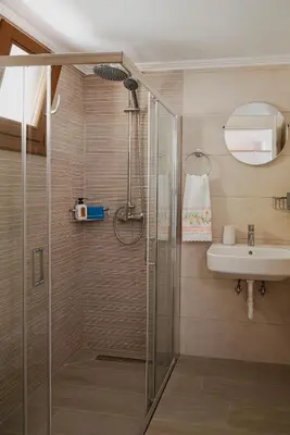 a bathroom with a shower and a sink at Oceanis apartment in Symi