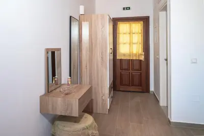 a bathroom with a wooden sink and a mirror at Oceanis apartment in Symi