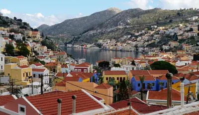 a view of a town with a body of water at Oceanis apartment in Symi