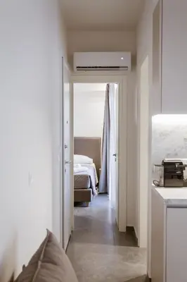 a room with a bedroom with a bed and a hallway at Luxury Apartments Of Colossus in Rhodes Town