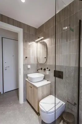 a bathroom with a toilet and a sink and a mirror at Luxury Apartments Of Colossus in Rhodes Town