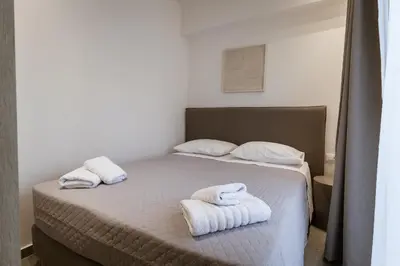 a bedroom with a bed with towels on it at Luxury Apartments Of Colossus in Rhodes Town