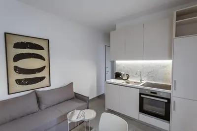 a living room with a couch and a kitchen at Luxury Apartments Of Colossus in Rhodes Town