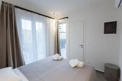 a bedroom with a bed with two towels on it at Luxury Apartments Of Colossus in Rhodes Town