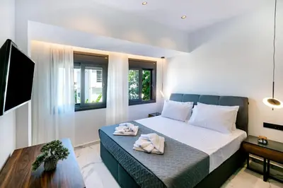 a bedroom with a bed and a table with towels on it at Rhodes Center Luxury Apartments #1 in Rhodes Town