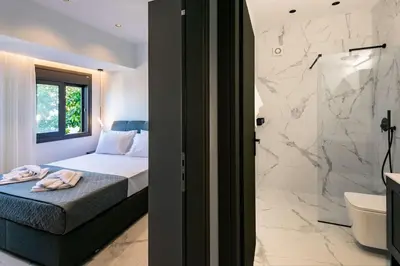 a bedroom with a bed and a bathroom with a shower at Rhodes Center Luxury Apartments #1 in Rhodes Town