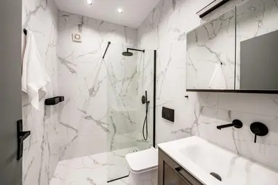 a white bathroom with a shower and a sink at Rhodes Center Luxury Apartments #1 in Rhodes Town