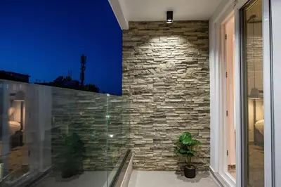 a room with a stone wall and a window at Smart Luxury Apartments #3 in Rhodes Town