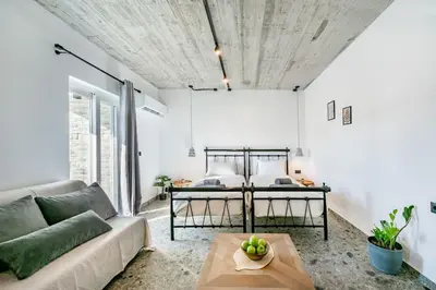 a living room with a couch and a bed at Smart Luxury Apartments #3 in Rhodes Town
