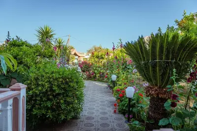 a garden with colorful flowers and a walkway at Casa Garden in Archangelos
