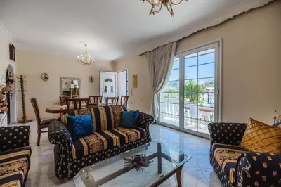 a living room with two couches and a glass table at Casa Garden in Archangelos