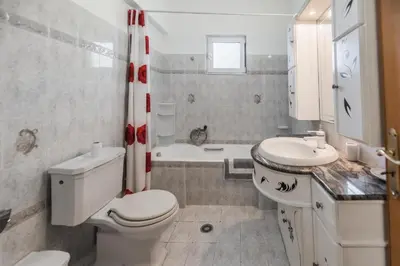 a bathroom with a toilet and a sink and a tub at Casa Garden in Archangelos